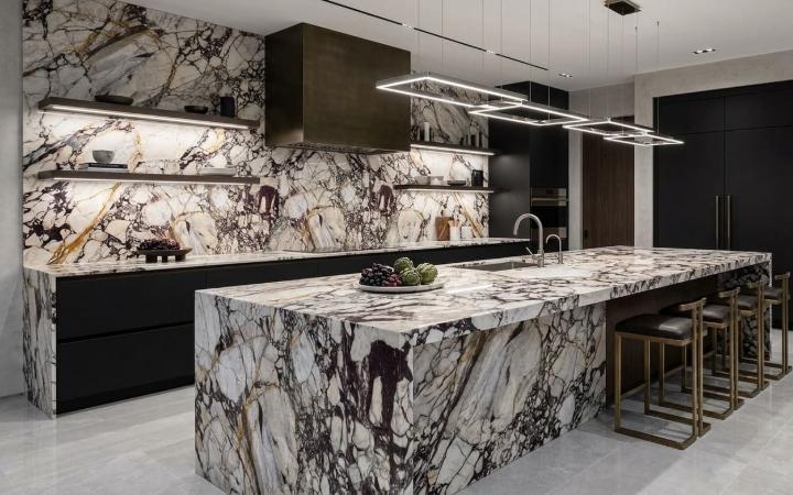 Kitchen with waterfall island and backsplash made of Calacatta Viola marble