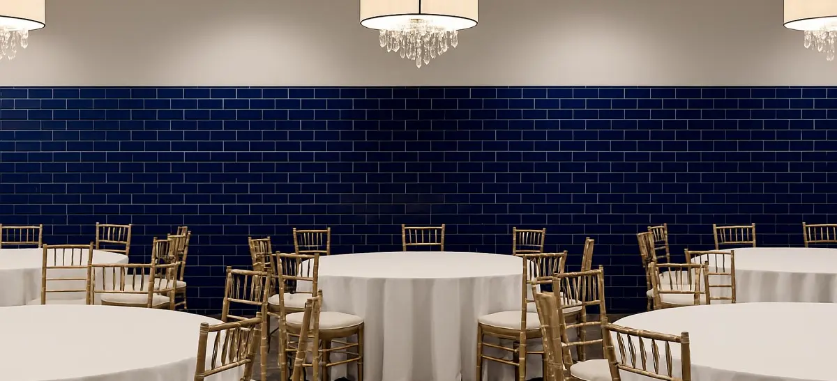 Dark blue subway tile wall in a high-traffic event space