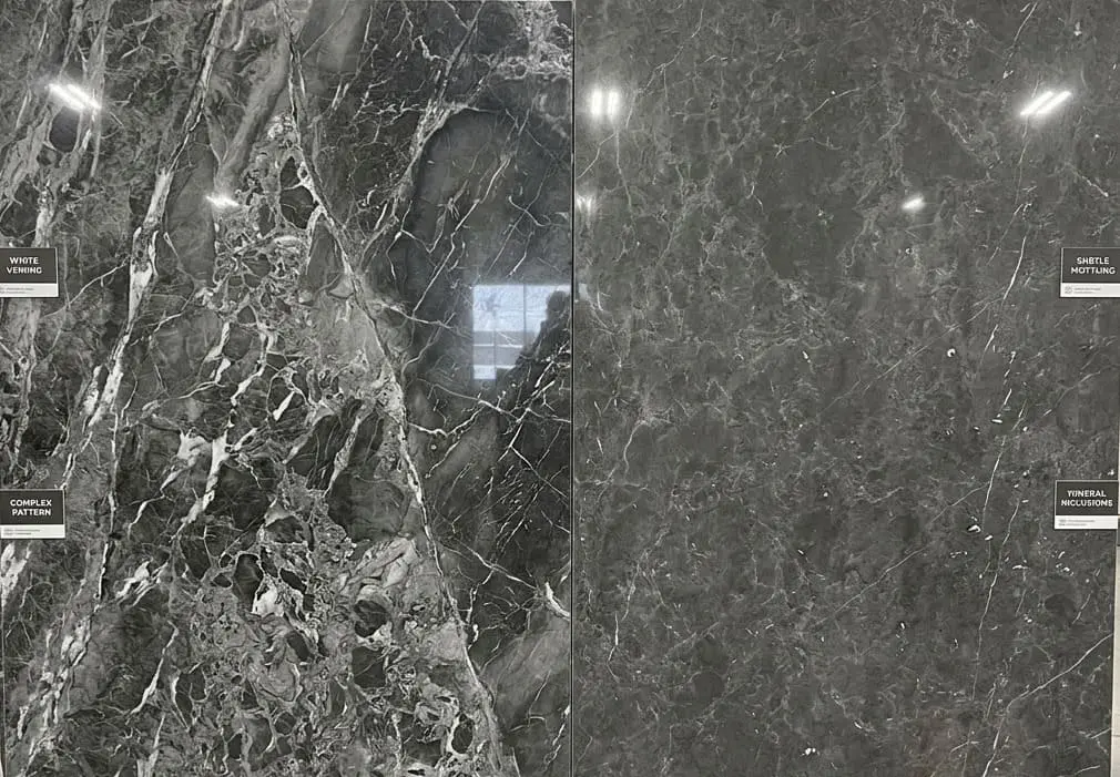 Slabs of dark grey marble, featuring white veining and mineral patterns