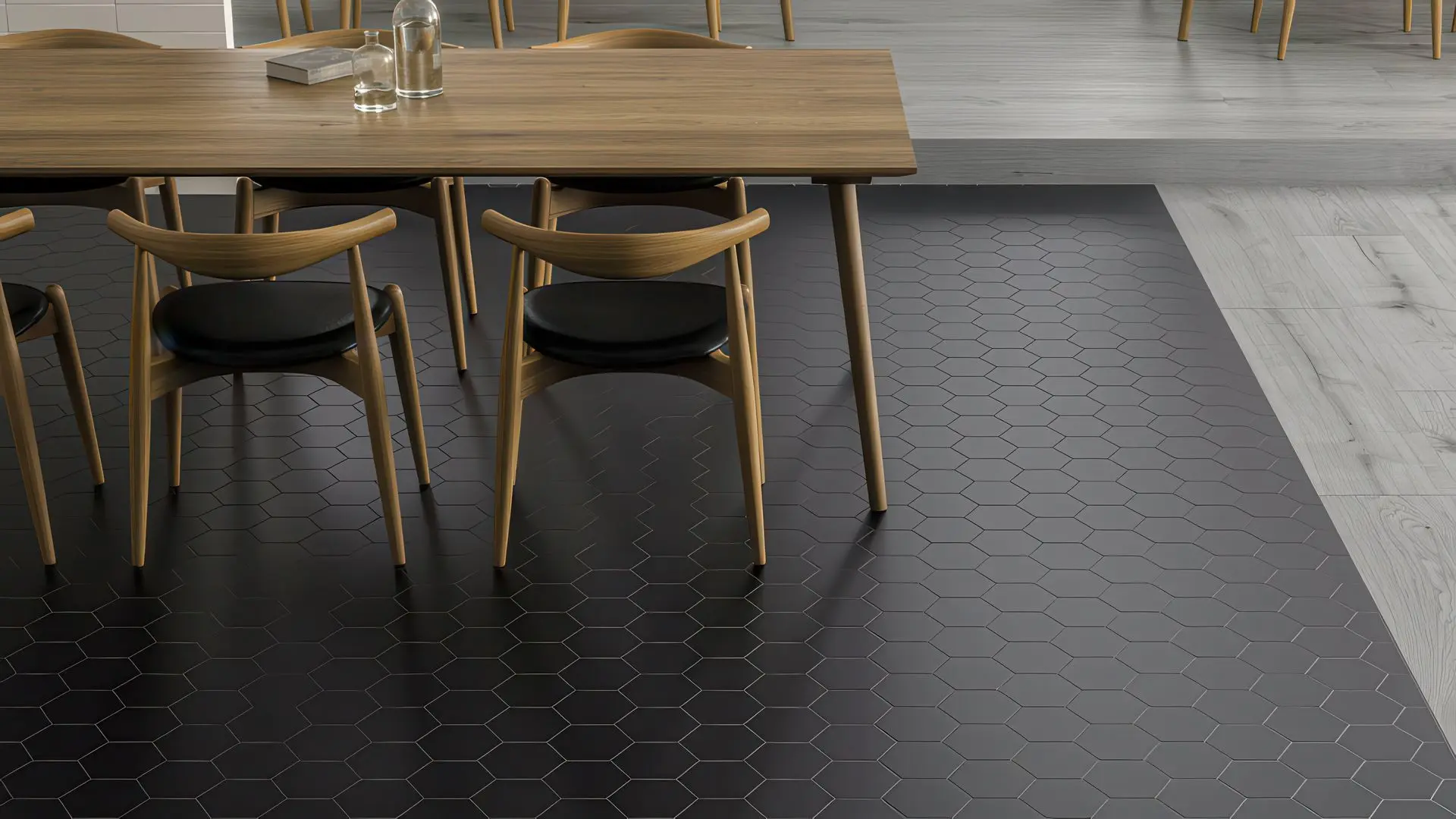 Black hexagon matte porcelain tile floor beneath a wooden dining table