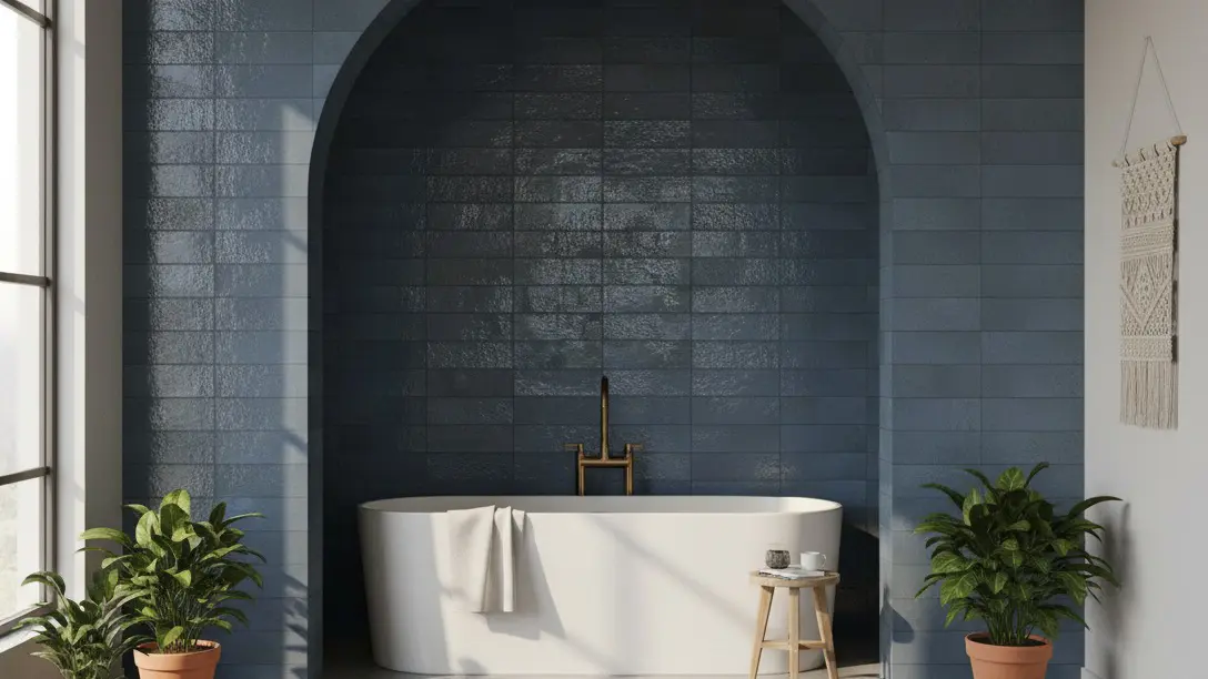 Minimalist bathroom with a white freestanding tub set in an arch tiled with deep blue Montera glossy subway tile
