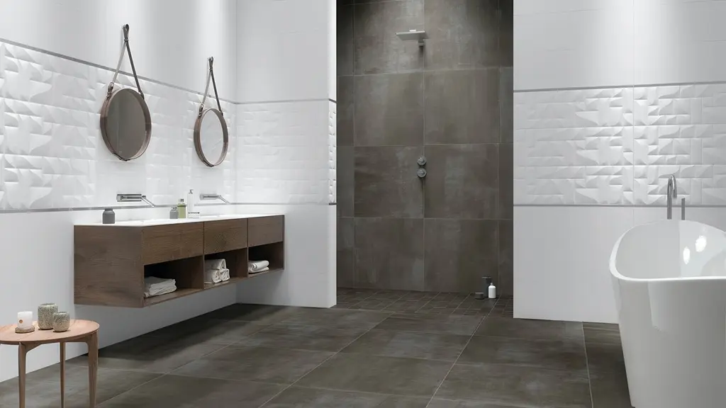 Modern bathroom with large format subway tile in the dark gray walk-in shower, a floating wood vanity, and a freestanding tub