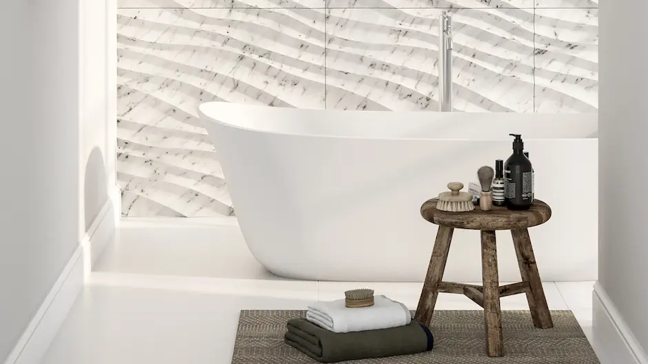 Serene bathroom with a freestanding tub against a wall of white marble-look textured subway tile