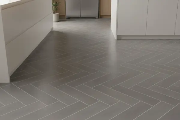 Herringbone subway tile backsplash in modern white kitchen with dark grout lines