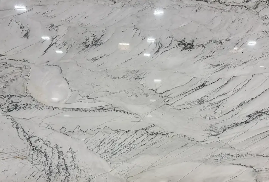 Statuario marble slab with bold gray veining against white background
