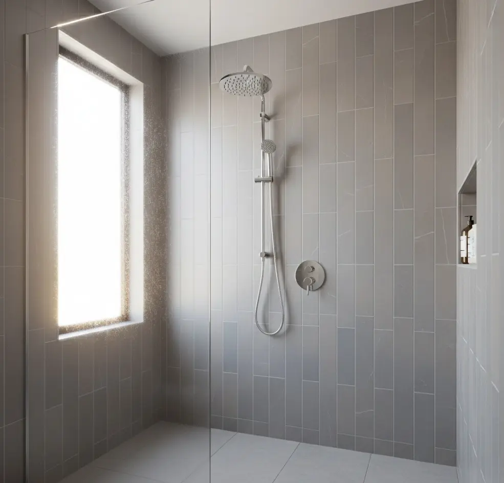 Conceptual rendering of vertical gray porcelain tile layout on shower wall with chrome fixtures and rainfall showerhead