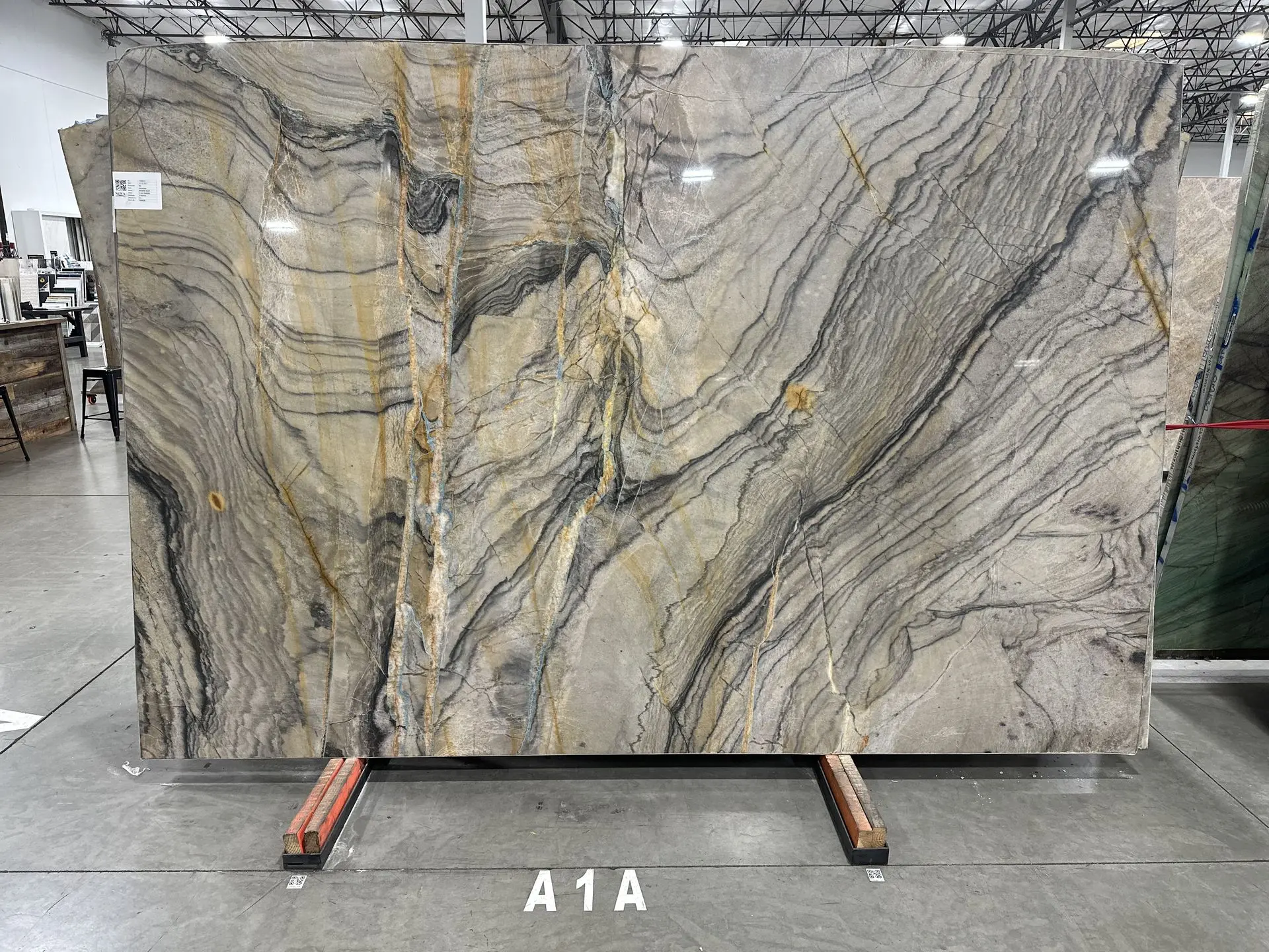 Marine Blue quartzite slab with gray and gold veining, polished finish