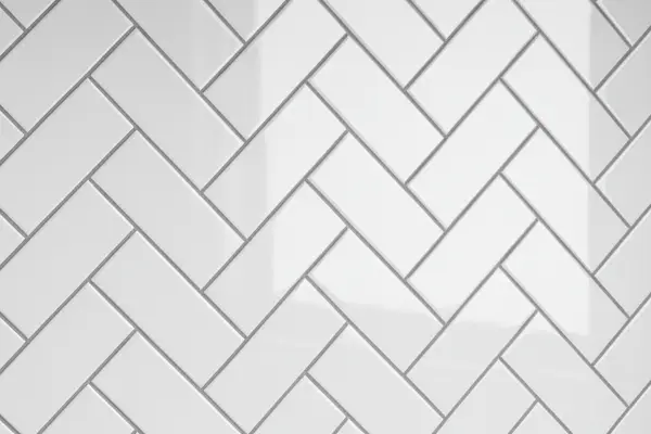 White subway tiles in herringbone pattern