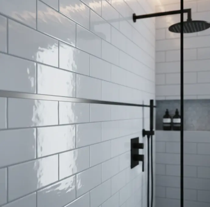 Glossy polished subway tiles on a bathroom wall with matching grout