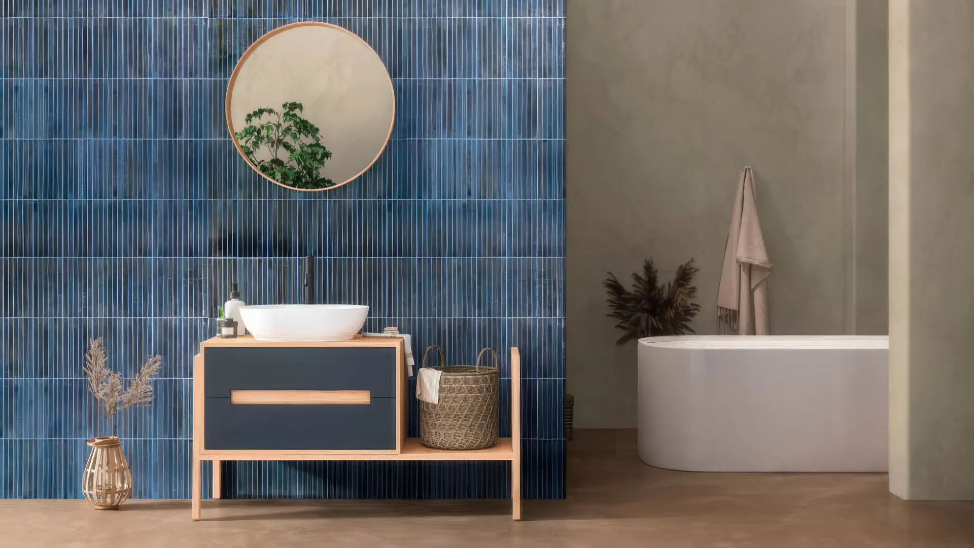 Bathroom accent wall with vertical blue large format subway tiles