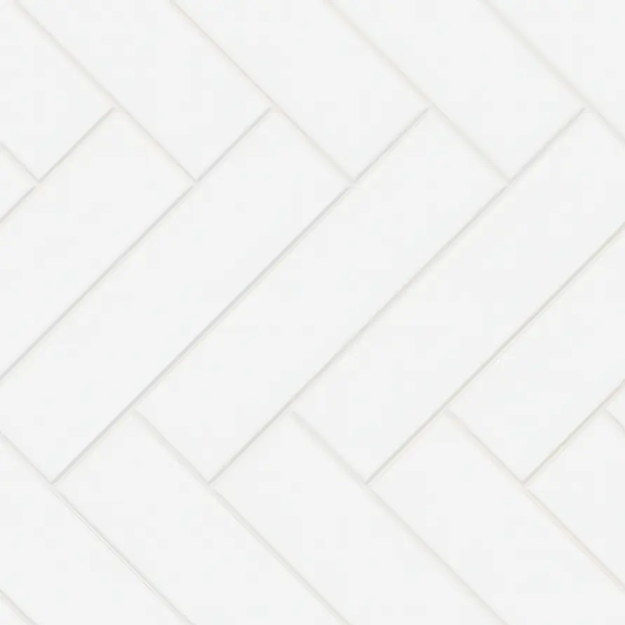 Matte white 3x12 porcelain subway tiles arranged in diagonal herringbone pattern.