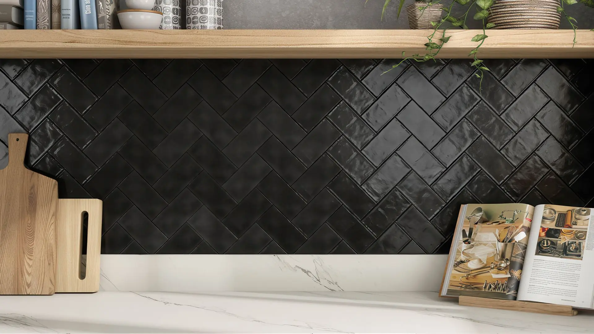 Black ceramic subway tiles in a glossy, herringbone pattern installed as a kitchen backsplash.