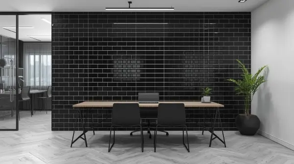 Black porcelain subway tiles on an office interior accent wall.