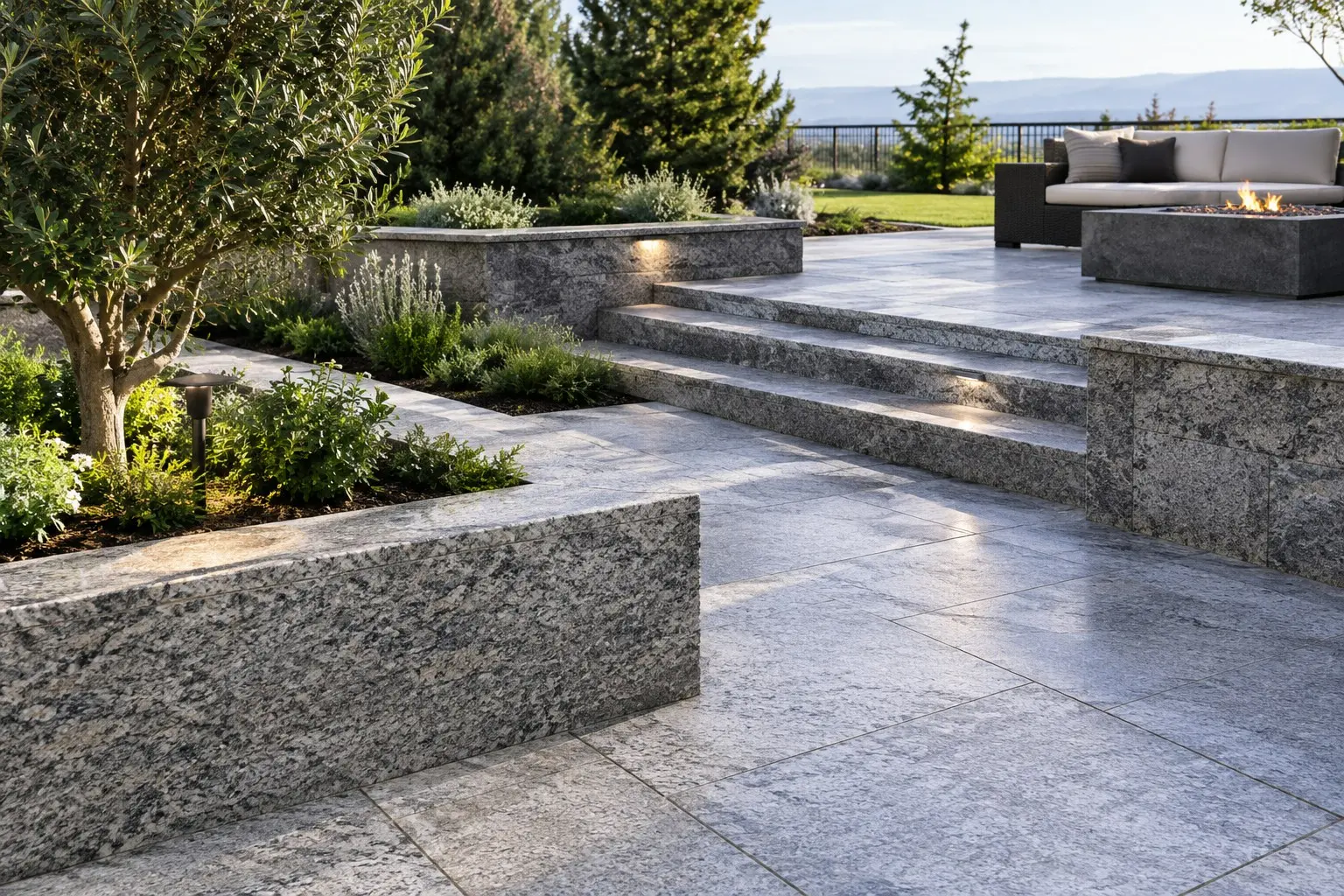 Conceptual rendering of a gray granite hardscape terrace with large-format pavers, raised planter walls, lit steps, and a fire pit.